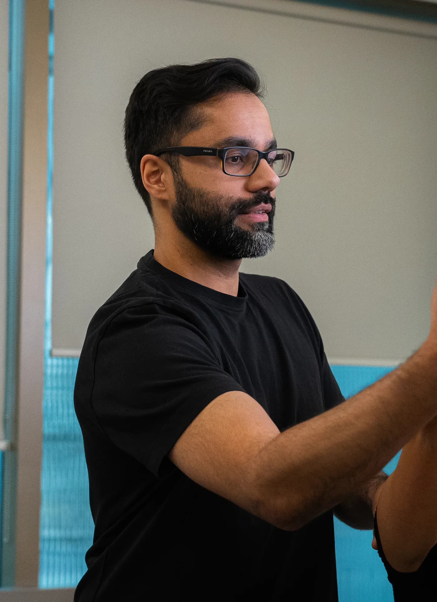 Hashim Saifuddin assessing a patient's shoulder