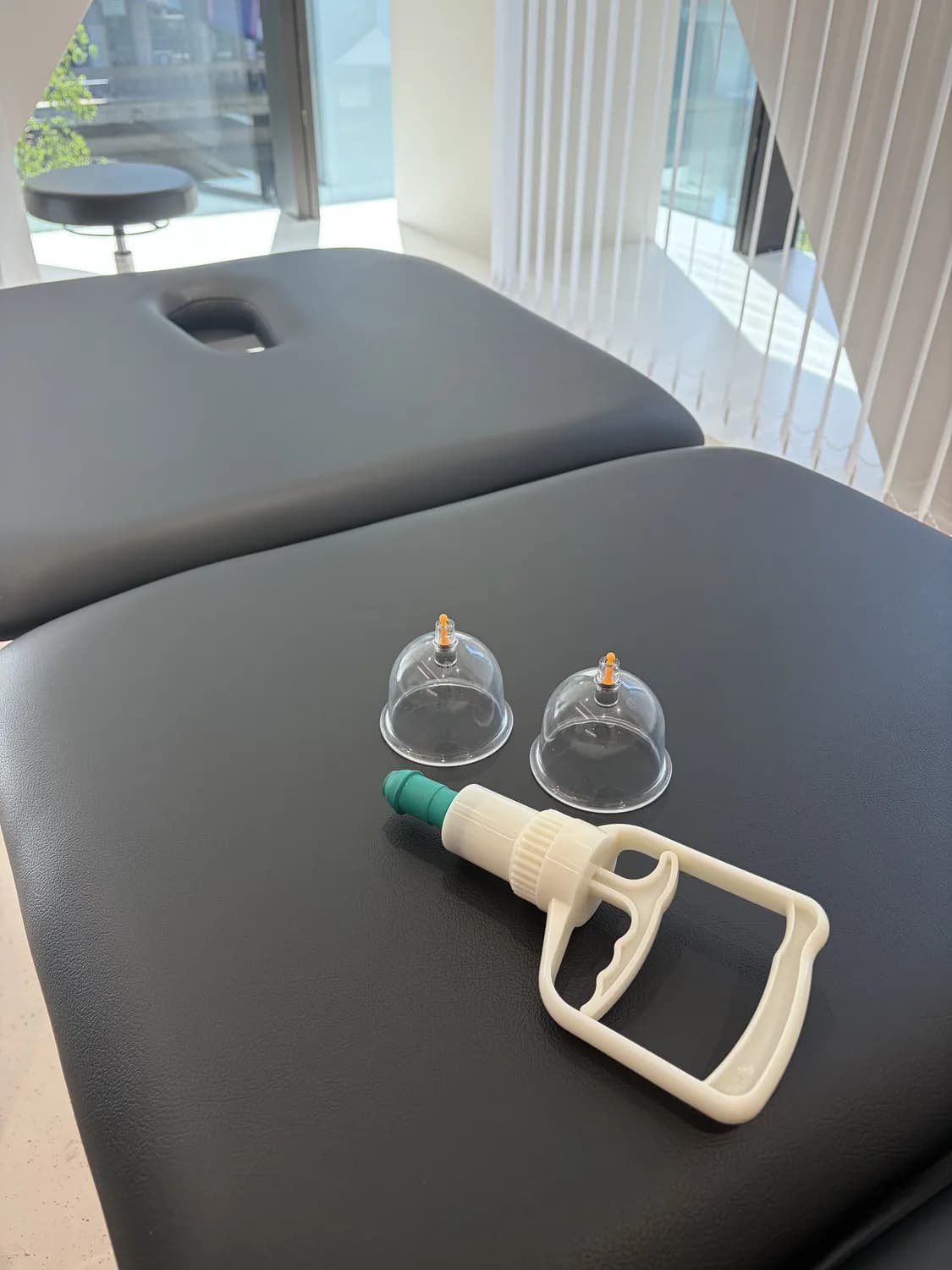 Cupping set laid out on the treatment table at the Atlas Osteopathy clinic.