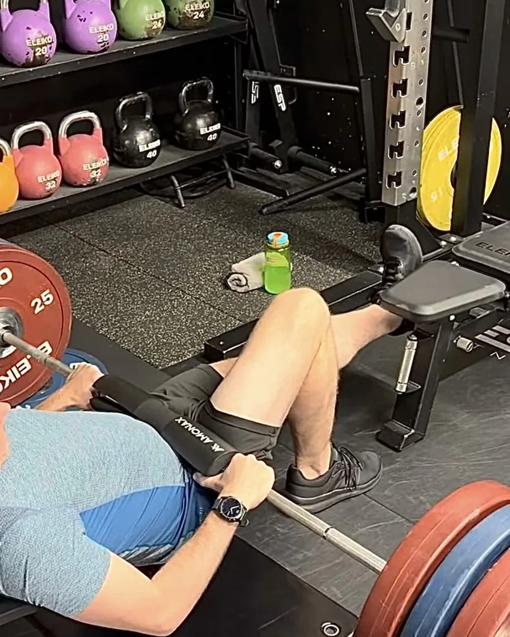 A patient working through a loaded lower-limb rehab exercise in the gym.